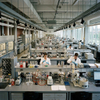 Higher education lab furniture featuring heavy-duty island benches and storage cabinets for student chemistry research