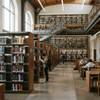 Higher education furniture layout featuring modular library shelving and student reading desks