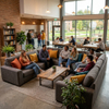 Comfortable U-shaped university sectional couch in a student housing recreation room with pattern rug and coffee table