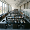 Custom physics laboratory furniture layout featuring central island benches and overhead utility piping