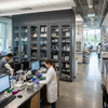 Floor to ceiling Glass Front Storage Cabinet integrated with dark grey University Lab Furniture
