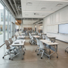 Modern corporate or academic training room equipped with mobile desks and chairs featuring locking casters, designed for a flexible learning environment.