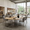 Curved modular library furniture setup featuring integrated power outlets in a sunlit university hall.