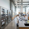 Row of custom stainless steel laboratory cabinets for chemical reagent storage in high-tech research lab