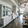 Custom university lab furniture featuring wall-mounted steel storage cabinets with glass doors