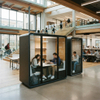 Modern two-person acoustic study pods with glass doors for focused work in a busy university library