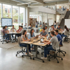 A dynamic, modern active learning classroom filled with college students collaborating at modular, mobile student desks and colorful ergonomic rolling chairs.