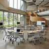 Flexible classroom sets of trapezoidal and triangular mobile desks and chairs arranged in modular pods to support diverse teaching methods in a modern school.